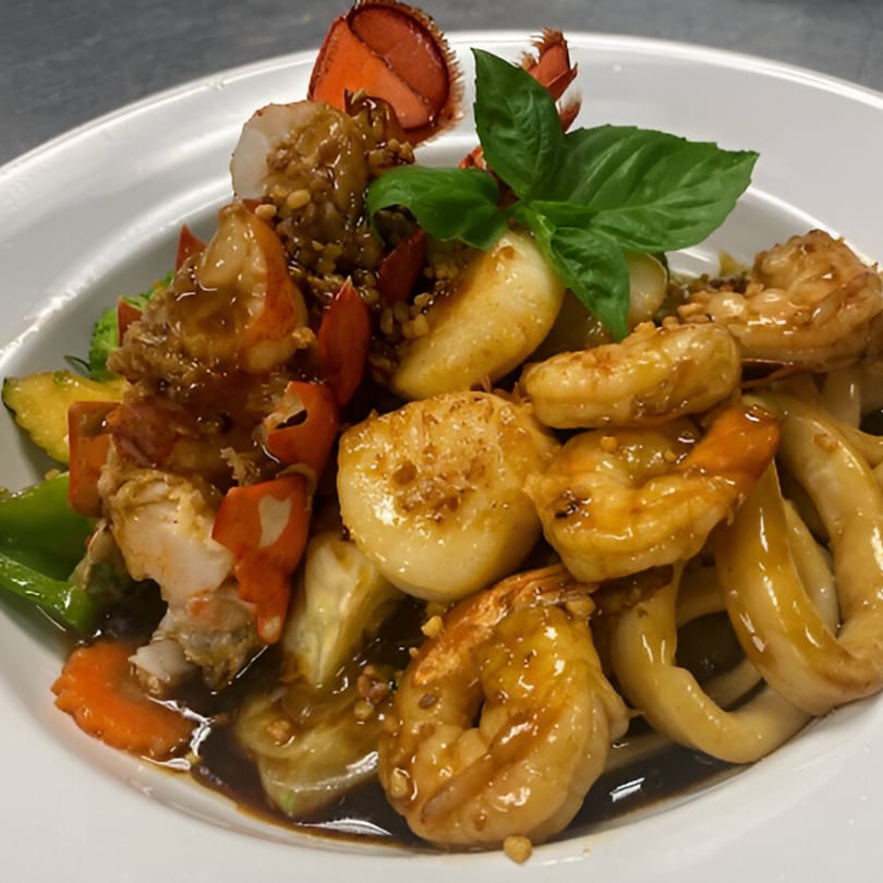 Royal Thai and Sushi's seafood dish with lobster, shrimp, scallops, calamari, and vegetables in sauce.